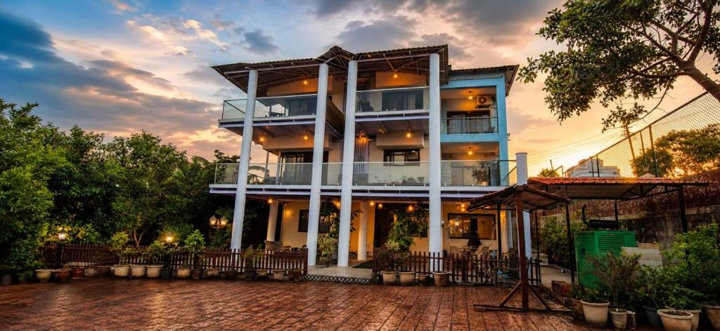 a building with a sunset in the background at Nirvana Inn in Mahabaleshwar