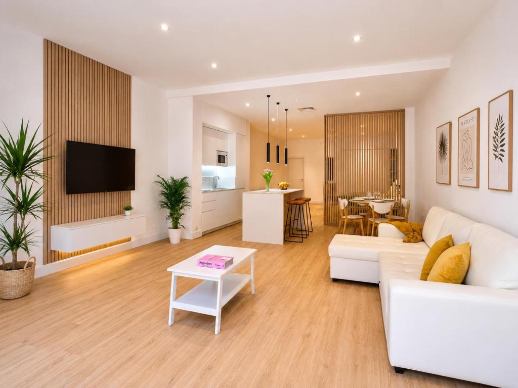a living room with a white couch and a table at Paseo Suites Hotel in Madrid