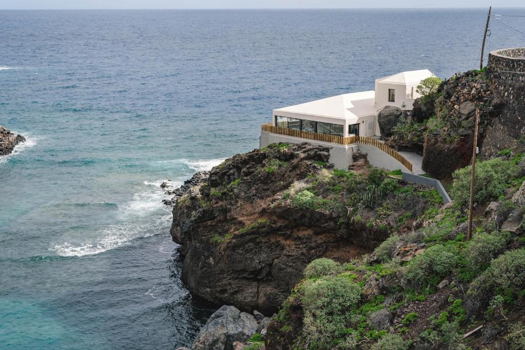 a house on a cliff next to the ocean at Villa Vista Suite by Aura Collection in Tamaduste