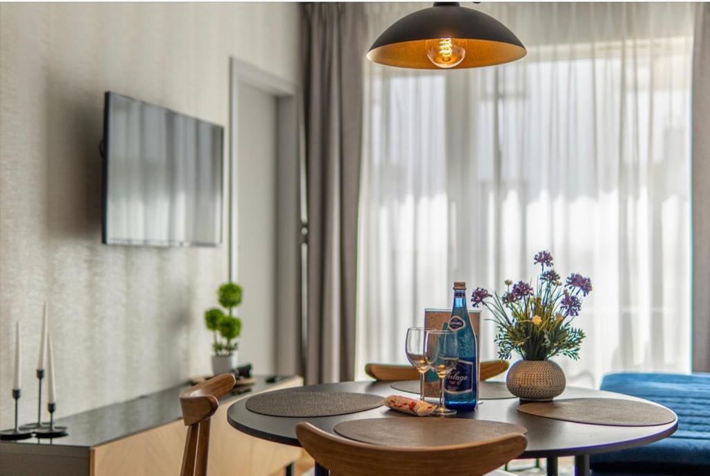 a dining room with a table with chairs and a dining room at Mechelinki Enjoy in Mechelinki
