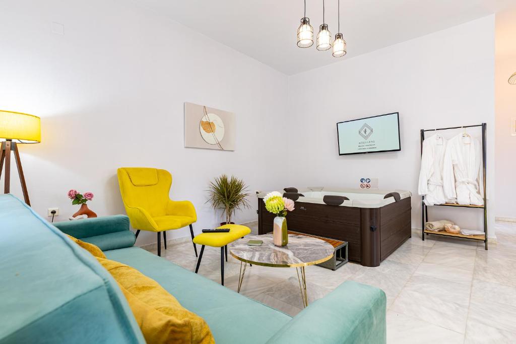 a living room with a blue couch and yellow chairs at Achilleas Deluxe House-Jacuzzi - BBQ in Kotsianá