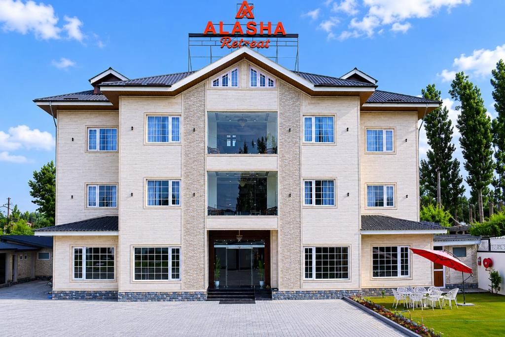 a large building with a sign on top of it at Alasha Retreat in Srinagar