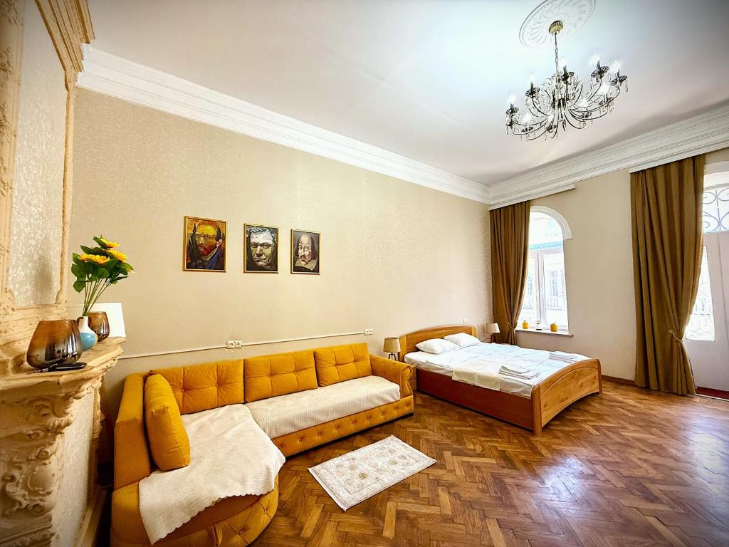 a living room with a couch and a bed at Gallery inn in Kutaisi