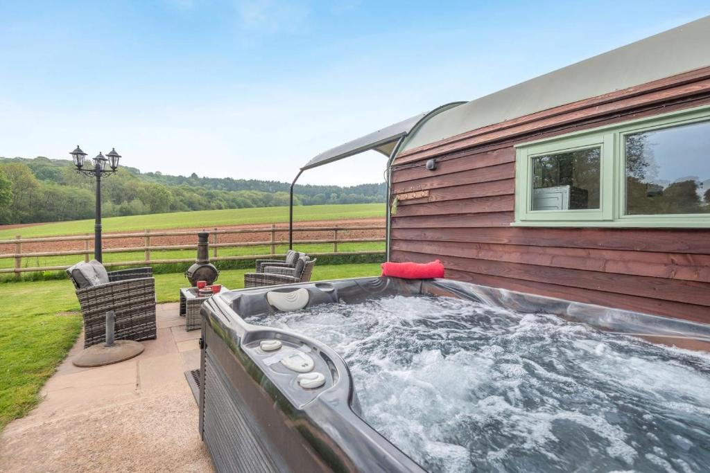 a hot tub on the side of a house at 1 Bed in Hereford oc-81292 in Aconbury