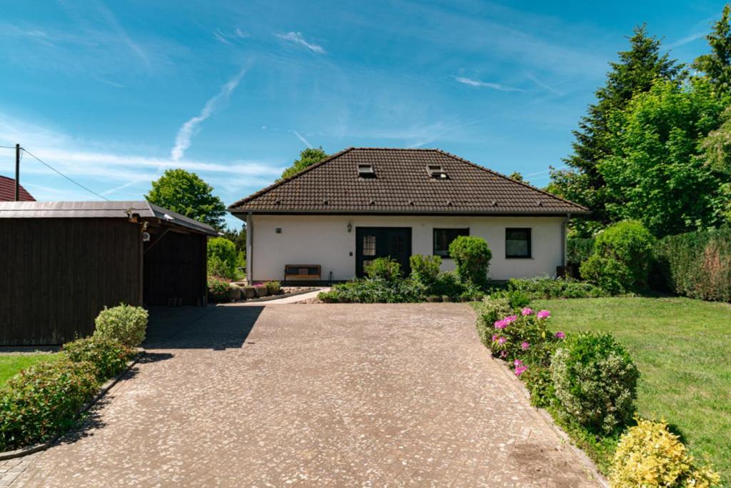 a house with a gravel driveway at Ferienhaus Sonneneck in Kluis