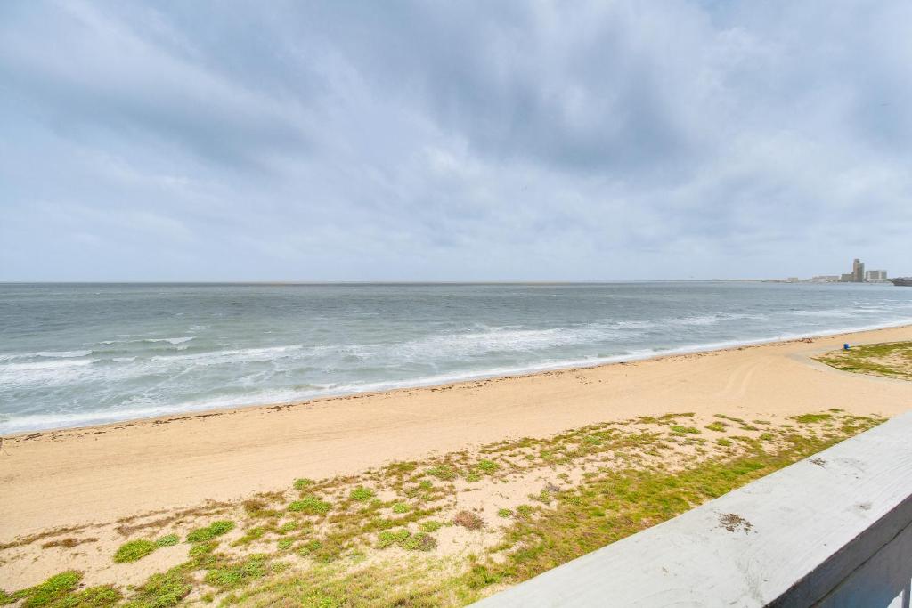 a beach with the ocean in the background at Unwind by the Beach | Pool and Oceanfront View in Corpus Christi