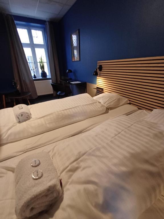 a bedroom with two beds and a window at Calm Room 10 on pedestrian street Saeby in Sæby