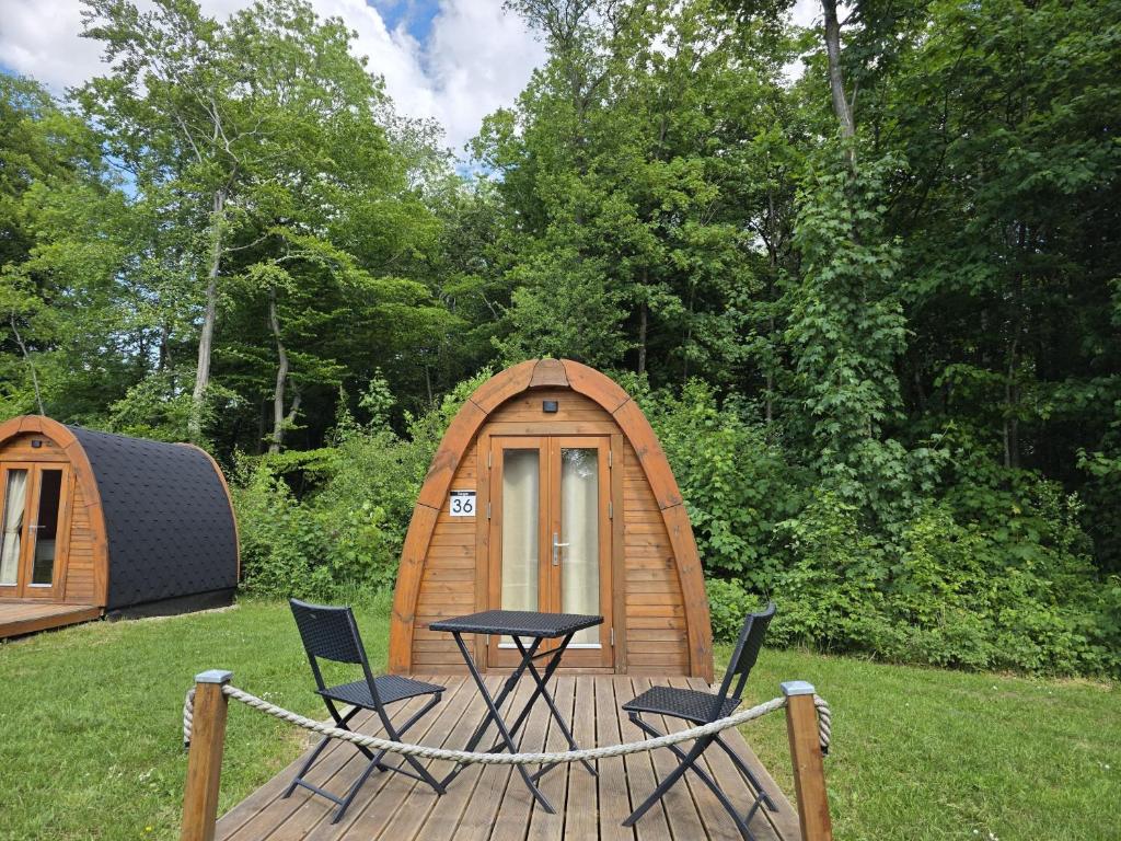 a wooden deck with chairs and a table and a tent at 36 Mini Pod "Sorge" in Silberstedt