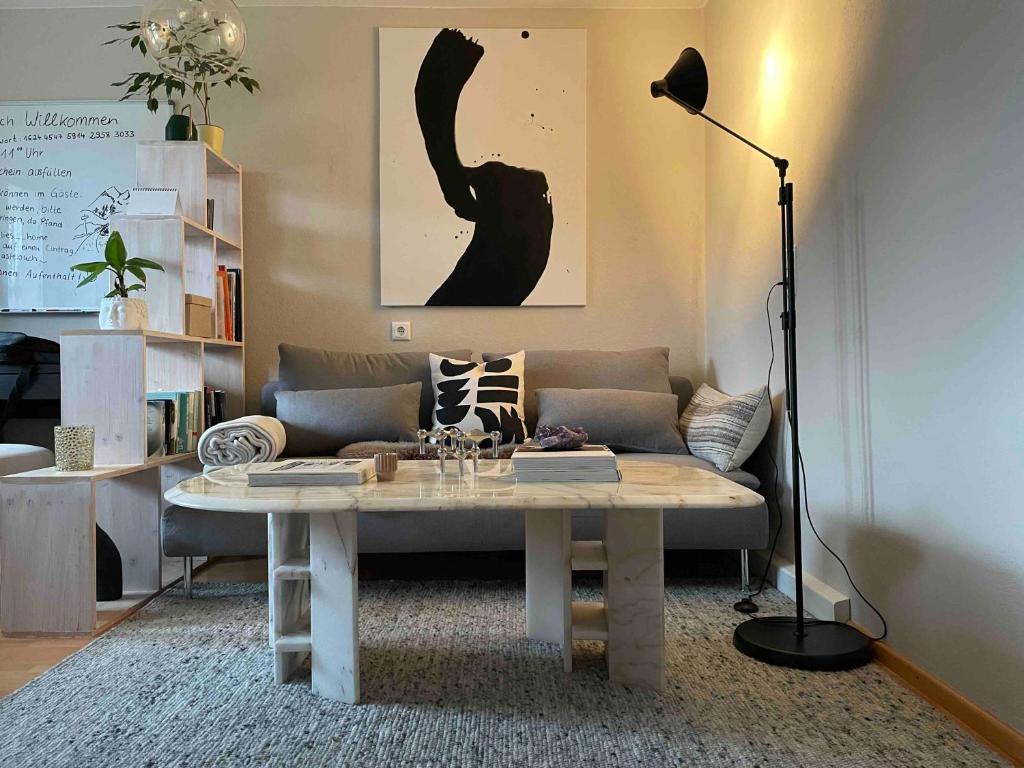 a living room with a couch and a table at Moderne Ruheoase Allgäu in Oberreute