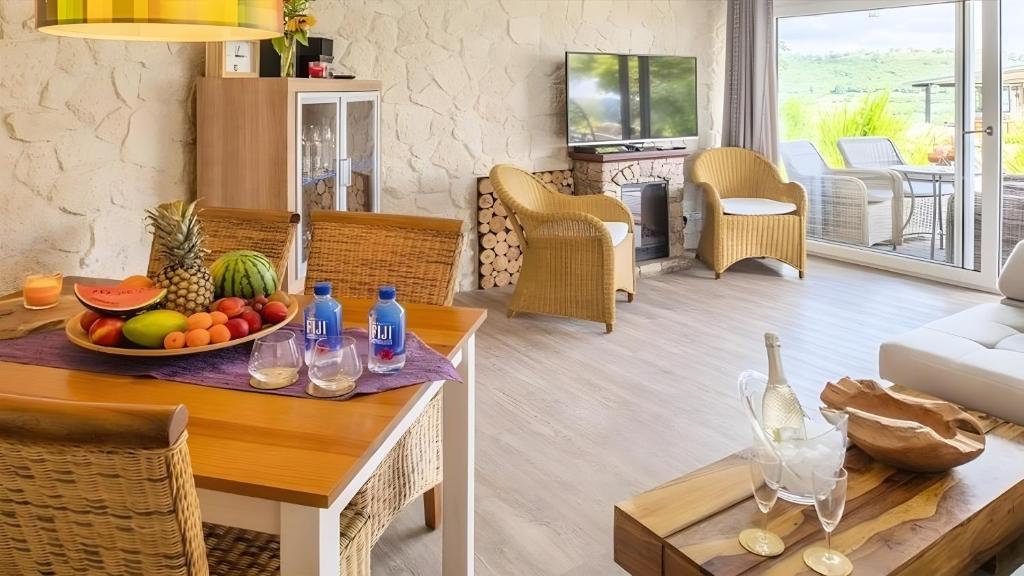 a living room with a table with a bowl of fruit at Apartment Seeterrasse in Schalkenmehren