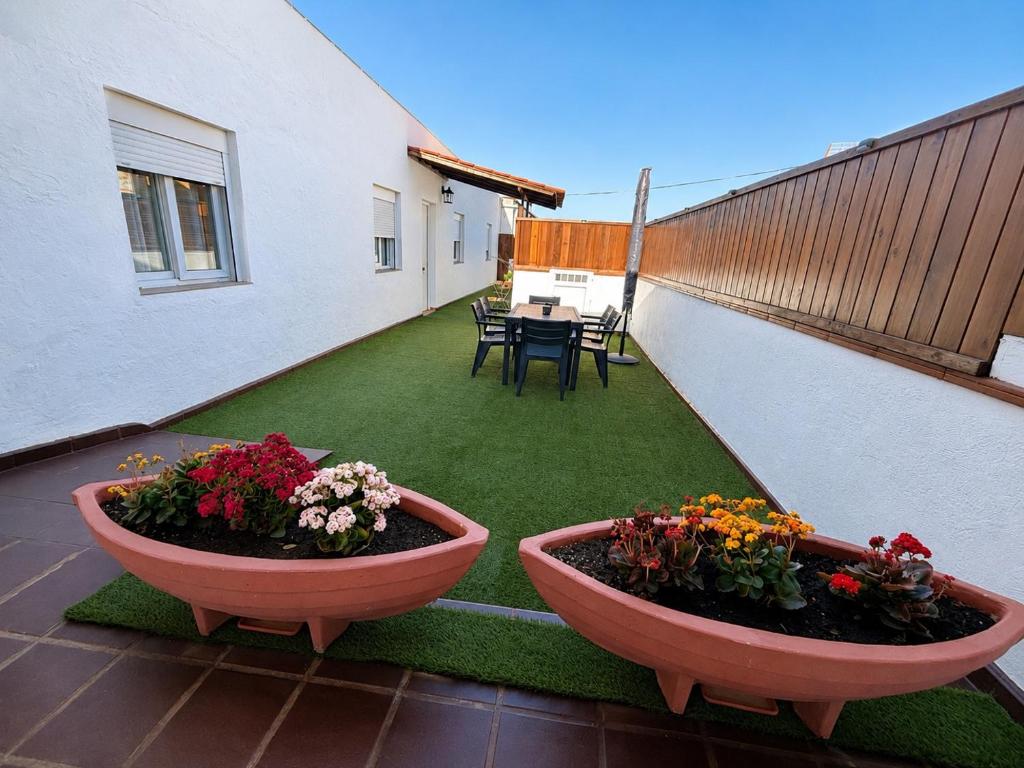 a patio with two large flower pots on a balcony at Casa Victoria in Antigua
