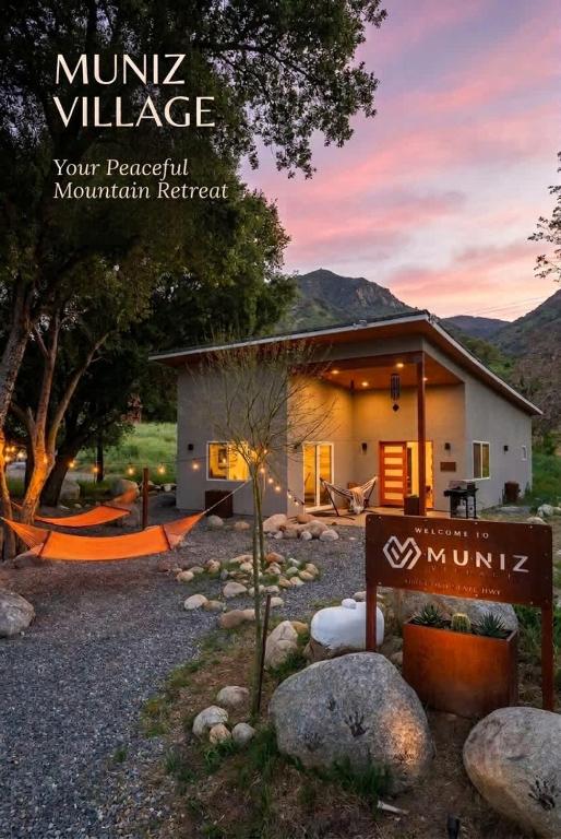 a small house with a sign in front of it at Muniz Village in Three Rivers