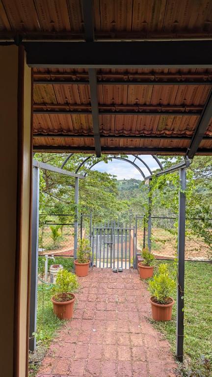 a brick walkway with potted plants on it at Kabani Villa in Mananthavady