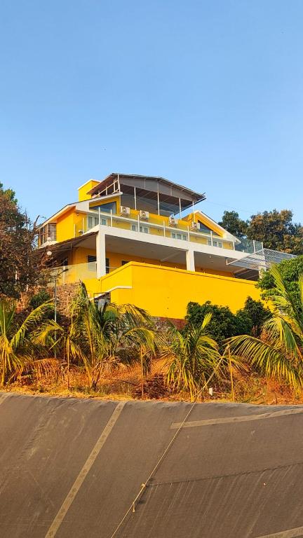 a yellow building on the side of a road at Valley View Villa Wai in Wai