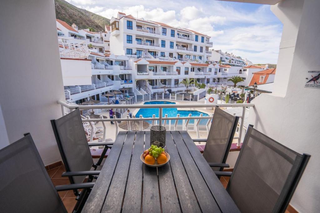 a wooden table with a bowl of fruit on a balcony at CASA VARGAS-TENERIFE in Los Cristianos