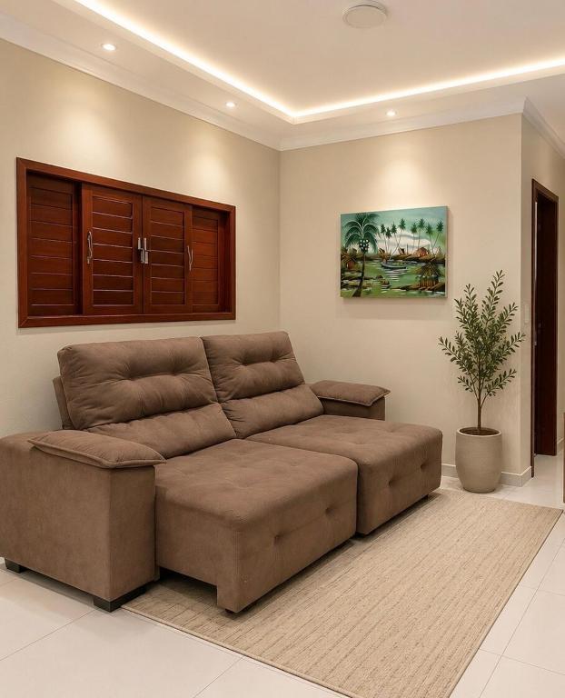 a large brown couch in a living room at Casa Nordestina in Nísia Floresta