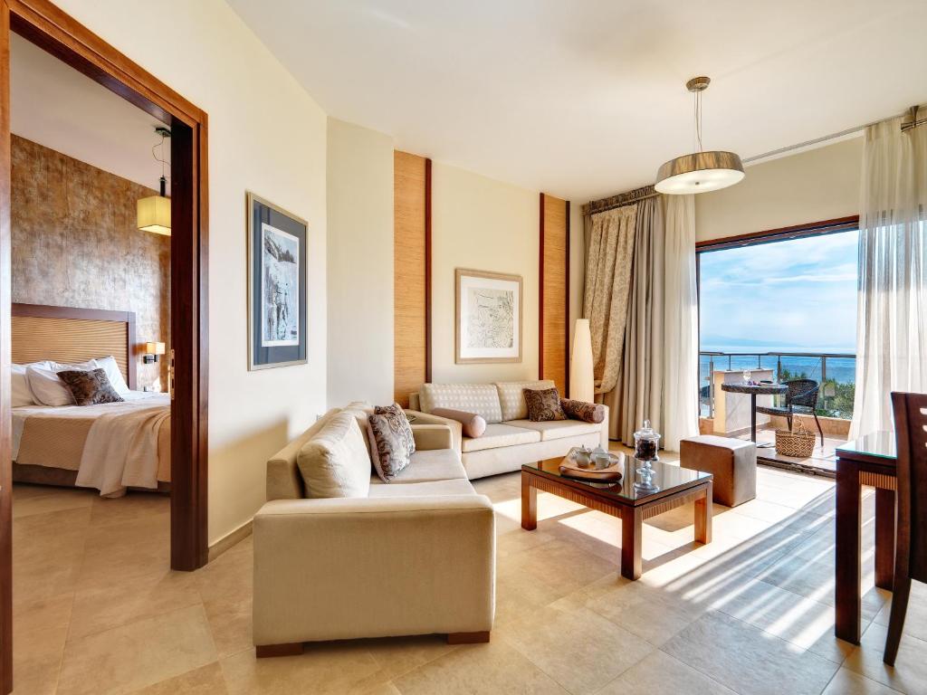 a living room with a couch and a bed at Olympion Sunset Halkidiki in Fourka