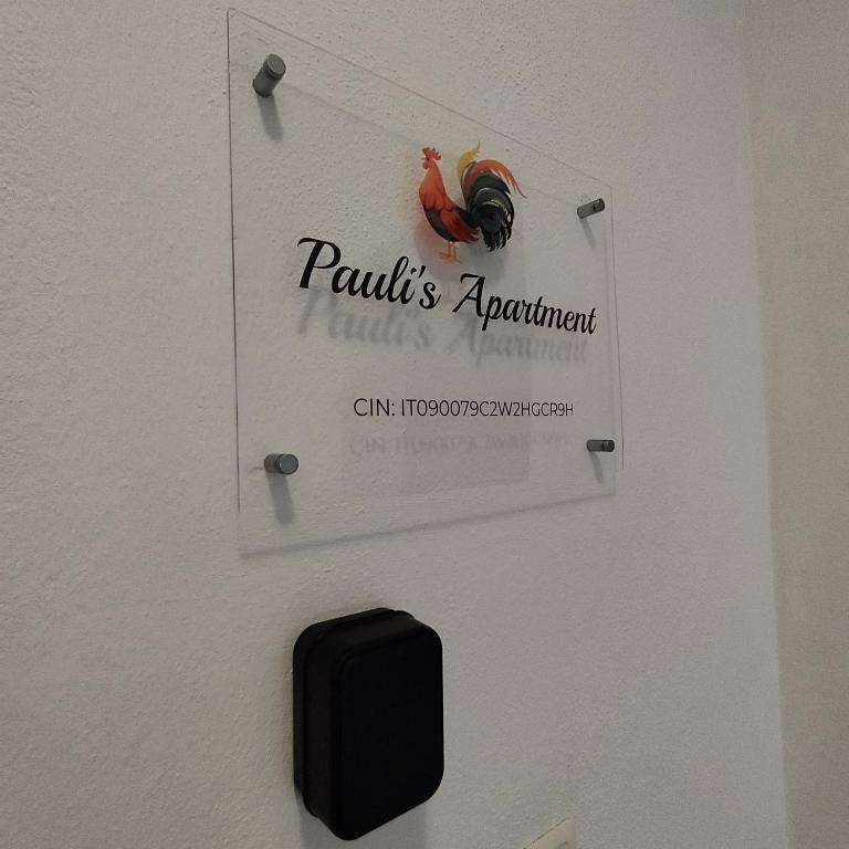 a sign on a wall with a sign for a restaurant at Pauli's apartment in Valledoria