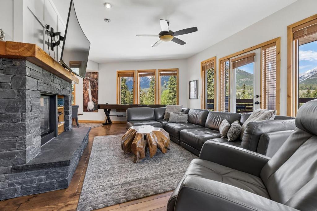 a living room with a couch and a fireplace at Rundle Cliffs Lodge by Canmore Premier in Canmore