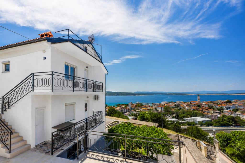 a white building with a balcony and the ocean at Tonka Roberta 2 in Crikvenica