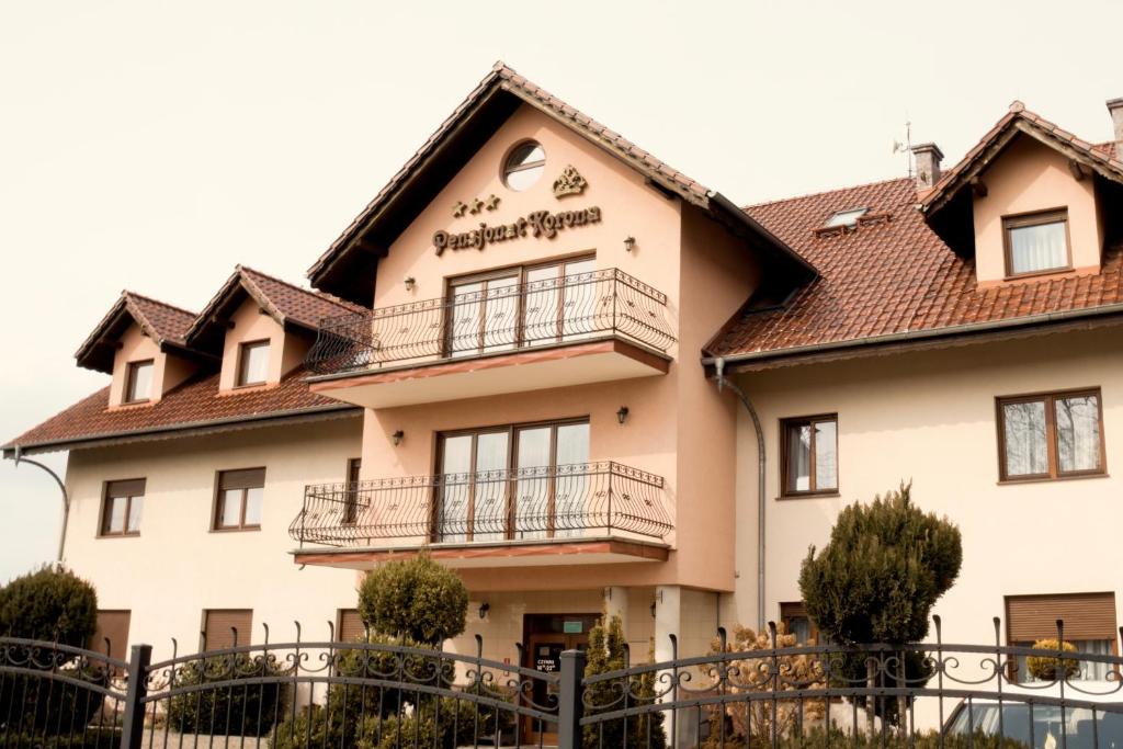 a building with balconies on the side of it at Pensjonat Korona in Modrzyca