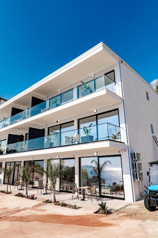 a large white building with a table in front of it at SeaScape Residence in Borsh