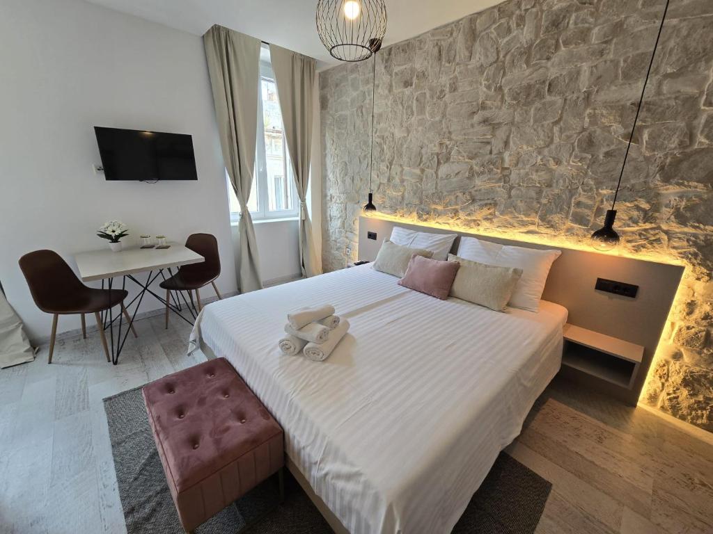 a bedroom with a bed with a teddy bear on it at Studio Apartments - Pula city center in Pula