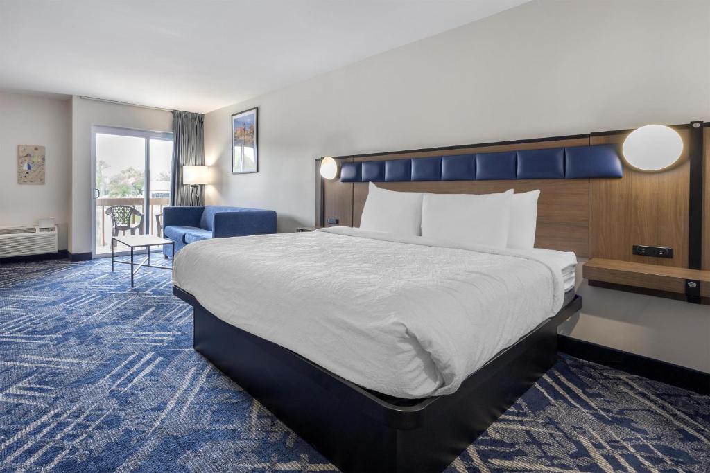a hotel room with a large bed and a chair at Best Western Indian Oak in Chesterton