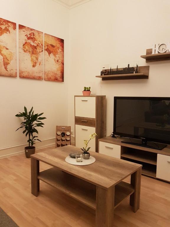 a living room with a coffee table and a flat screen tv at City Apartment in Düren - Eifel
