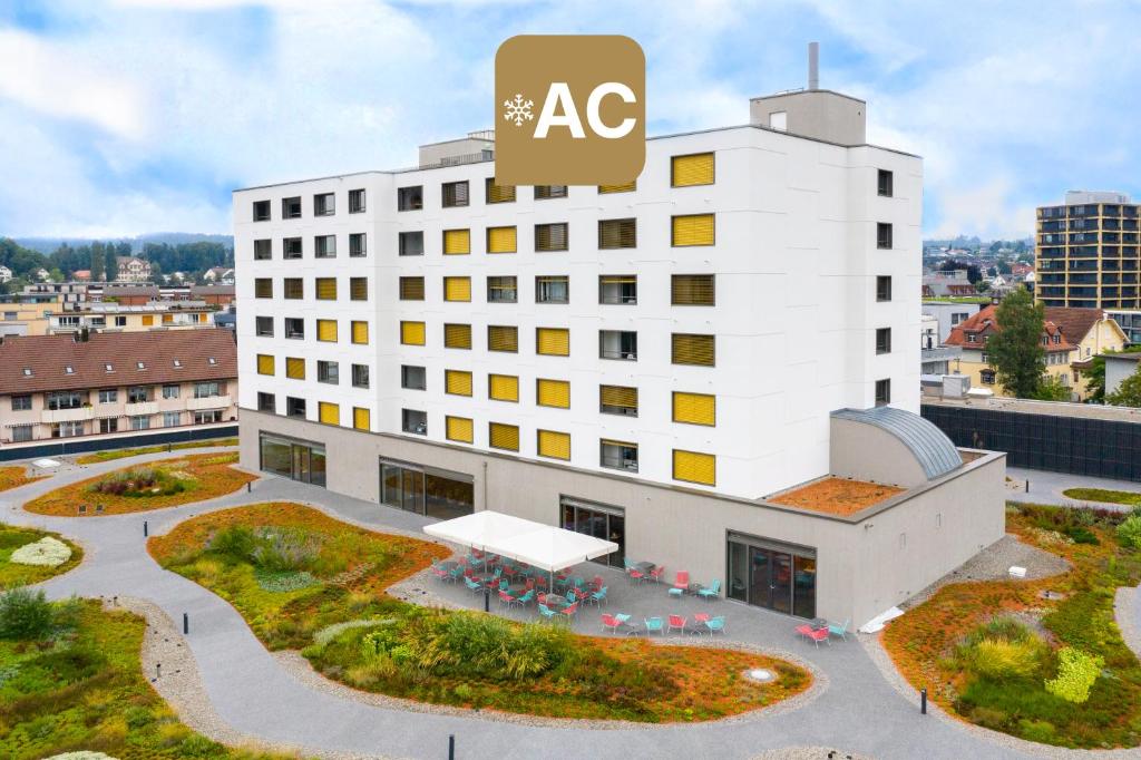an office building with an ac sign on top of it at HOTEL illuster - Urban & Local in Uster