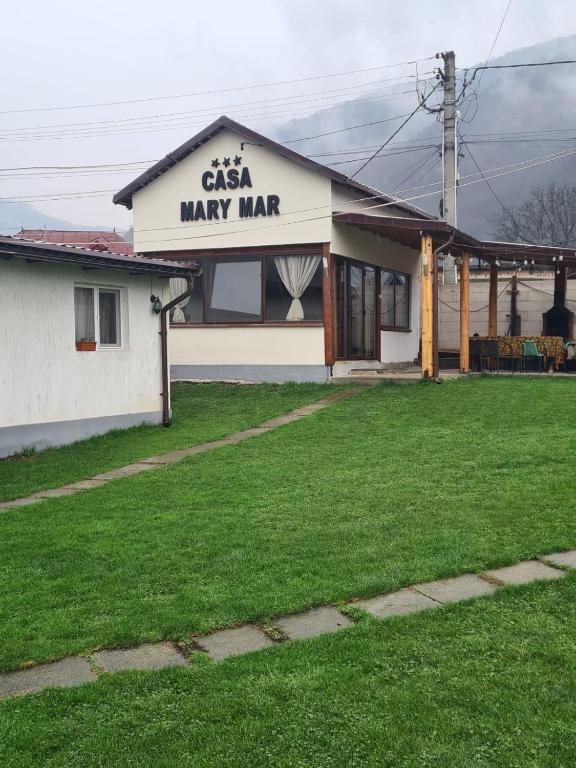 a building with a sign that reads cash may markup at Casa Mary Mar in Târgu Ocna