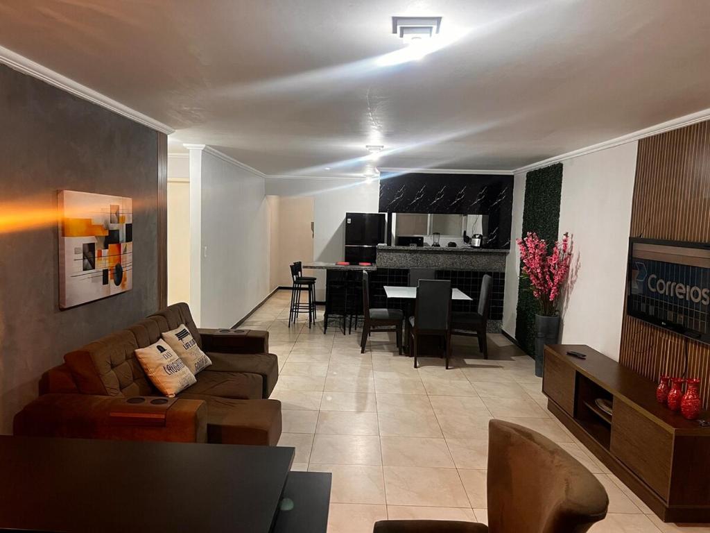 a living room with a couch and a dining room at Smart & Comfort 4 - Ap completo in Campina Grande