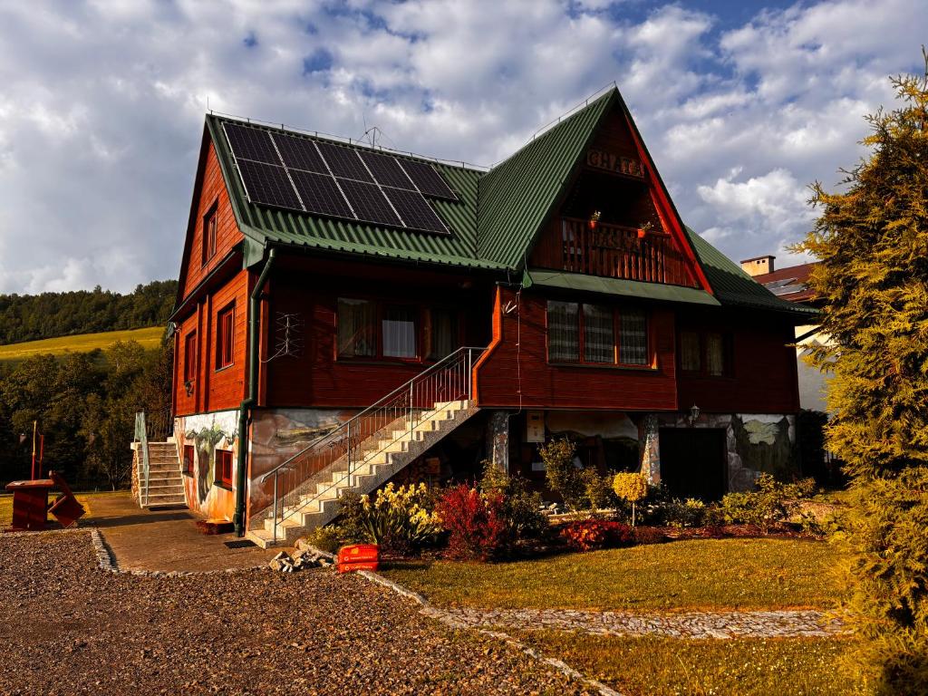 a house with solar panels on the roof at Chata Baśka in Baligród
