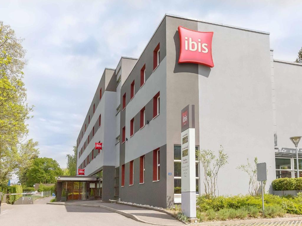 a hotel with aubs sign on the side of a building at ibis Genève Aéroport in Geneva