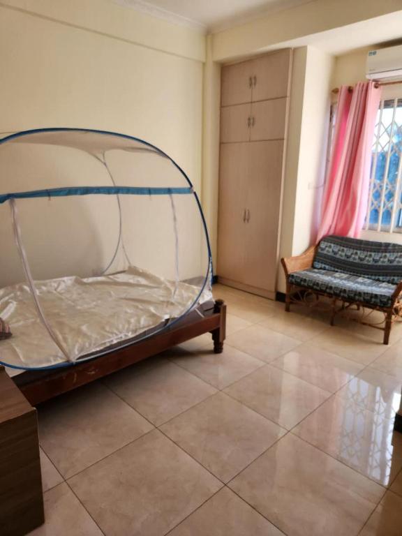 a bedroom with a bed and a bench in a room at Happy Lodge in Sakumona