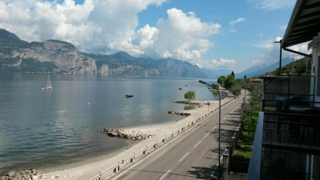 a view of a beach next to a body of water at Haus and Beach in Brenzone sul Garda