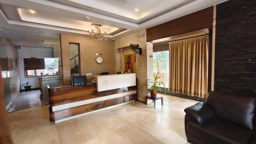 a living room with a couch and a piano at Hotel Surya Palace - Durg Railway Station in Durg