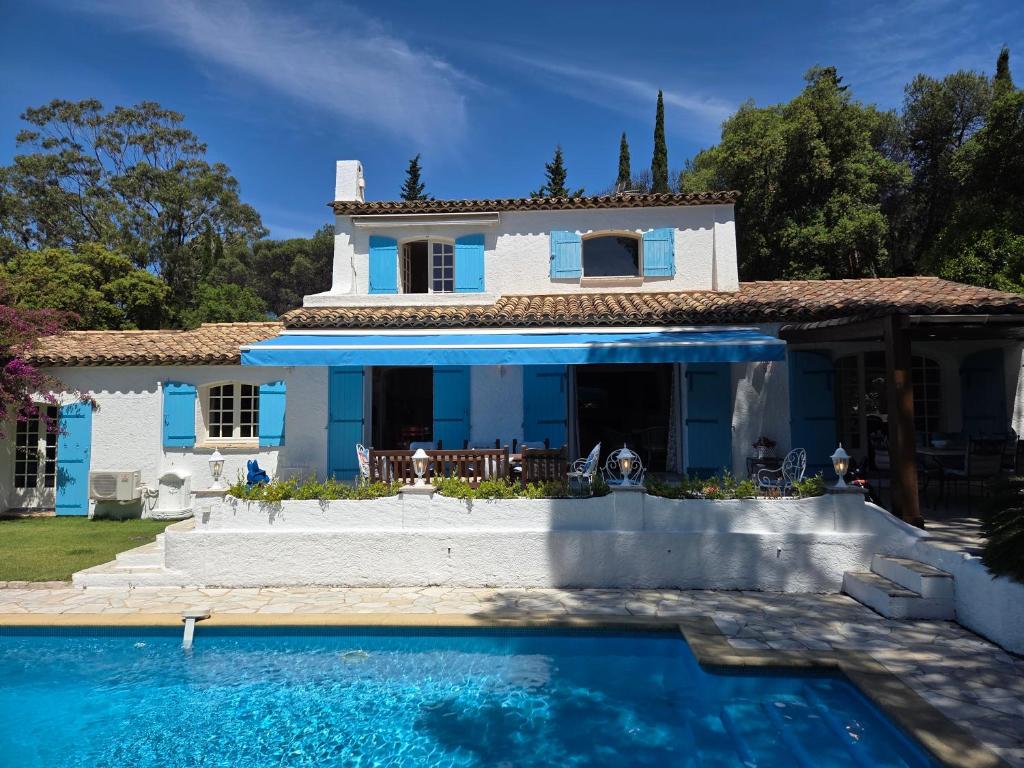 a villa with a swimming pool in front of a house at Villa Provençal StTropez Ramatuelle Pampelonne beach in Saint-Tropez