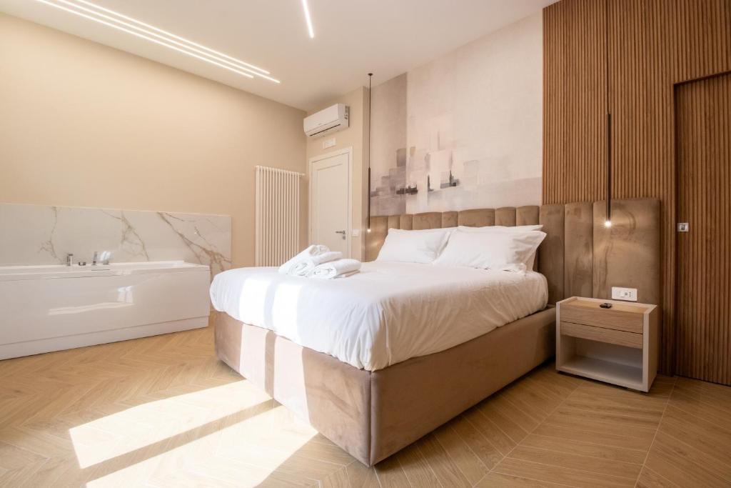 a bedroom with a large bed and a bath tub at Live in Gaeta in Gaeta