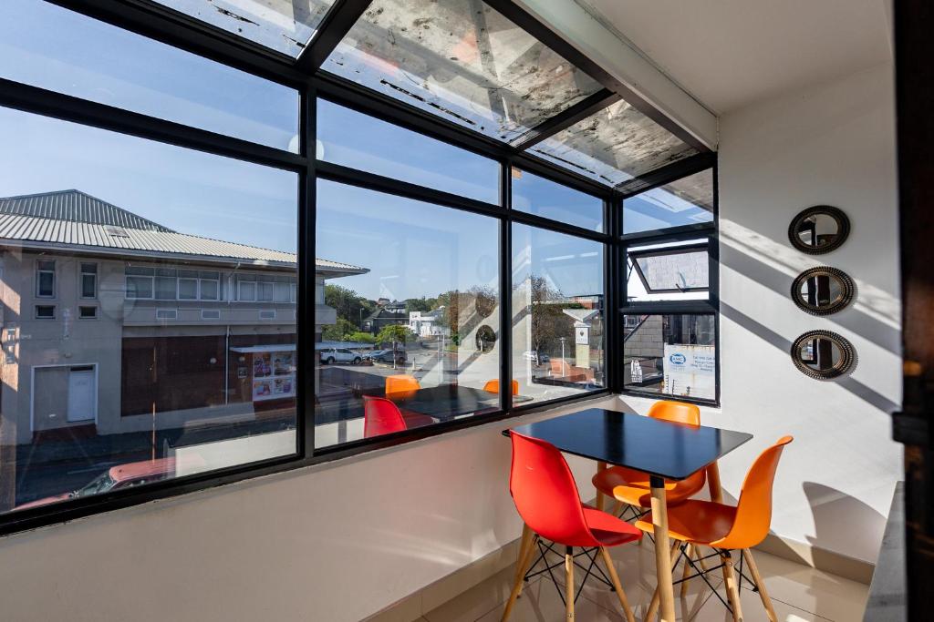 a room with a table and chairs in front of a window at Safi Luxury Apartment 6 - 2 bedroom in East London
