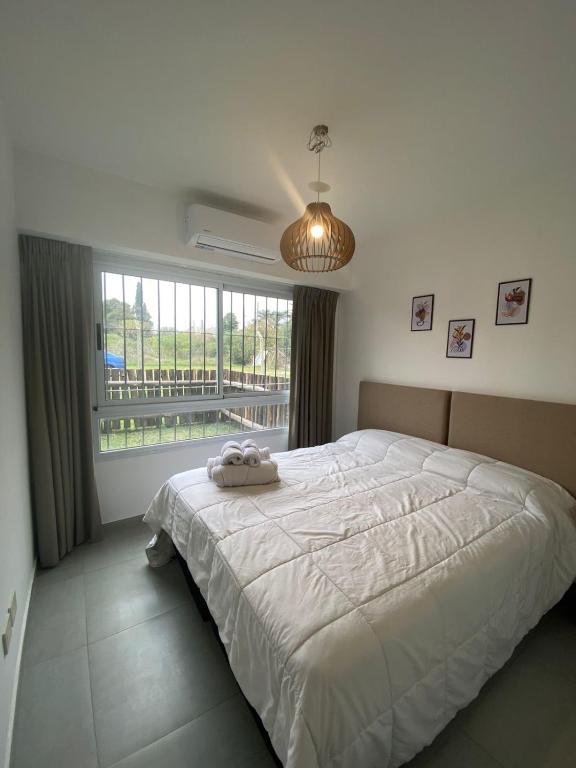 a bedroom with a large bed and a large window at Sunny Stay Ezeiza in Ezeiza