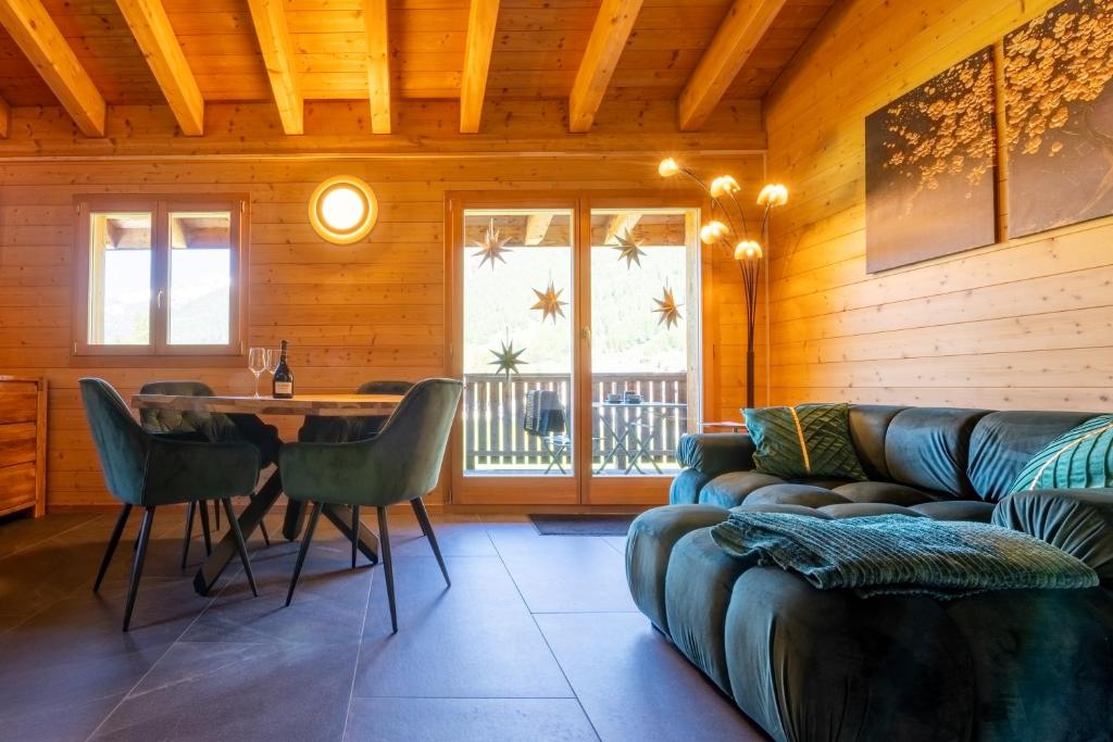 a living room with a couch and a table at Ferienwohnung Aegimatte in Ulrichen
