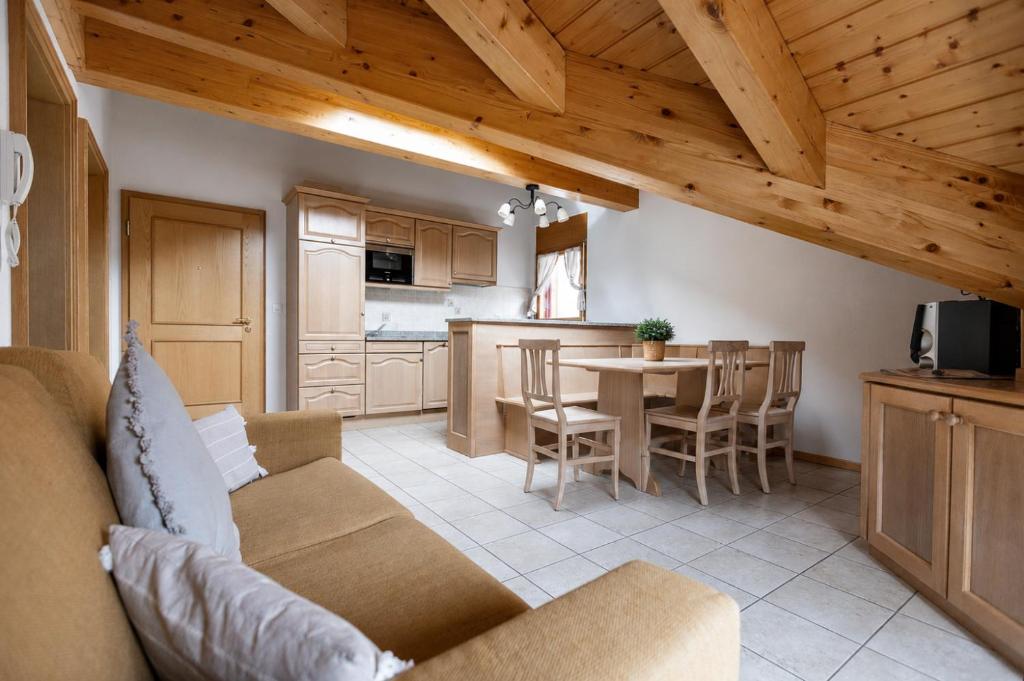 a living room and kitchen with a couch and a table at Residenz Château Leukerbad in Leukerbad