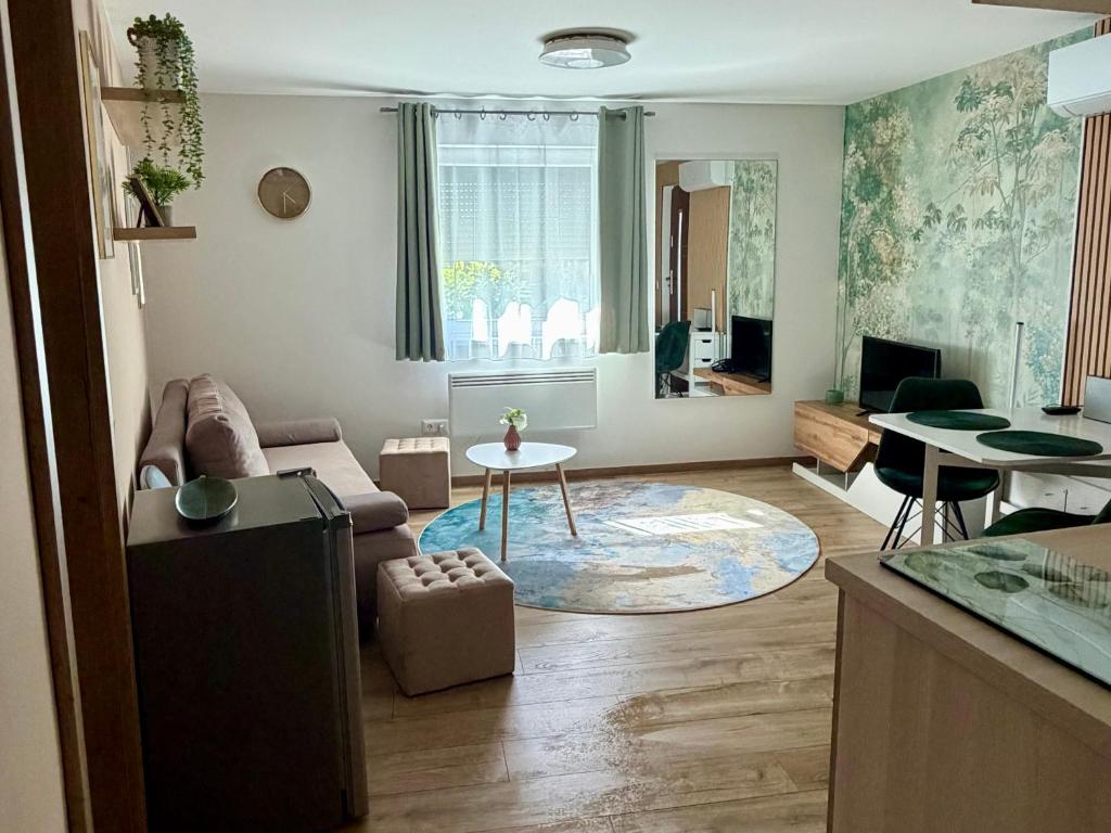 a living room with a couch and a table at Puzzle Haus in Gyenesdiás