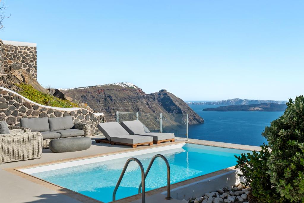 a villa with a pool and a view of the ocean at Neraé Santorini in Imerovigli