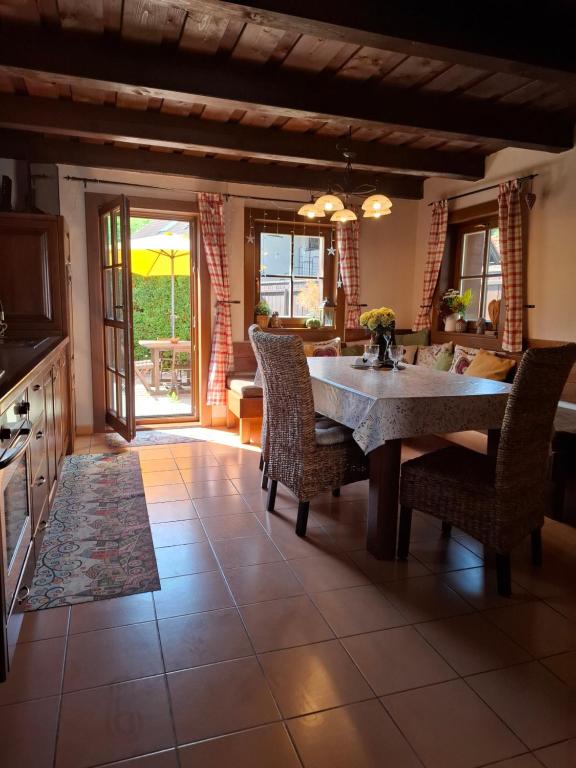 a kitchen with a table and chairs in a room at Chata DOBROTKA in Liptovský Mikuláš