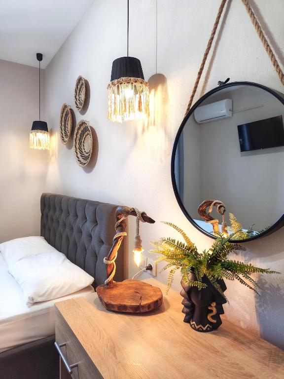 a room with a couch and a table with a mirror at GreKa apartments in Kalives Poligirou