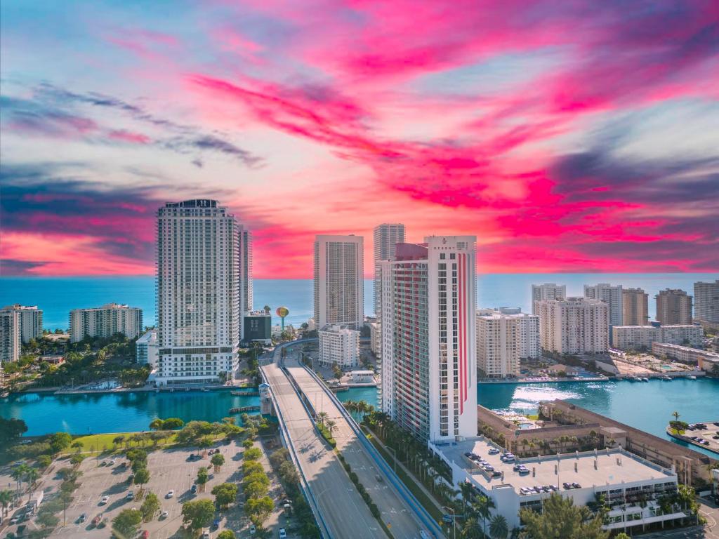 a city skyline with a red cloudy sky at Beachwalk Resort in Hallandale Beach