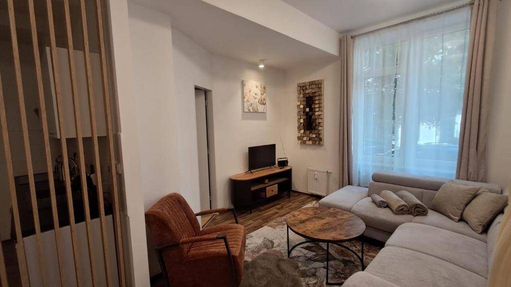a living room with a couch and a table at Kolonáda in Poděbrady