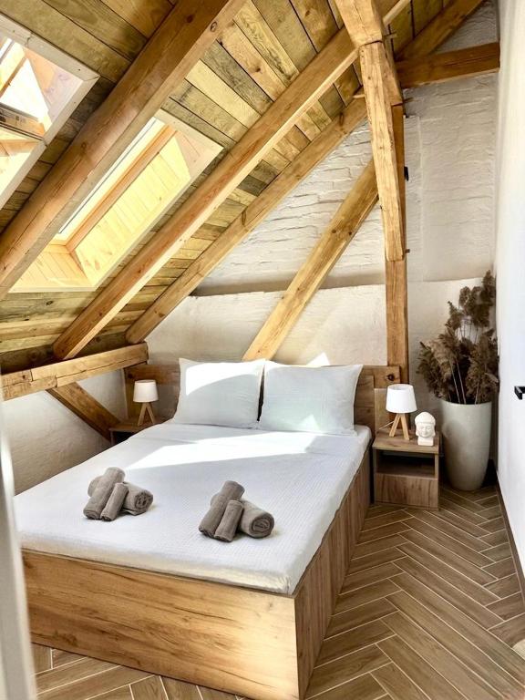 a bedroom with a bed with two towels on it at Przystań Jeziorna in Pasym